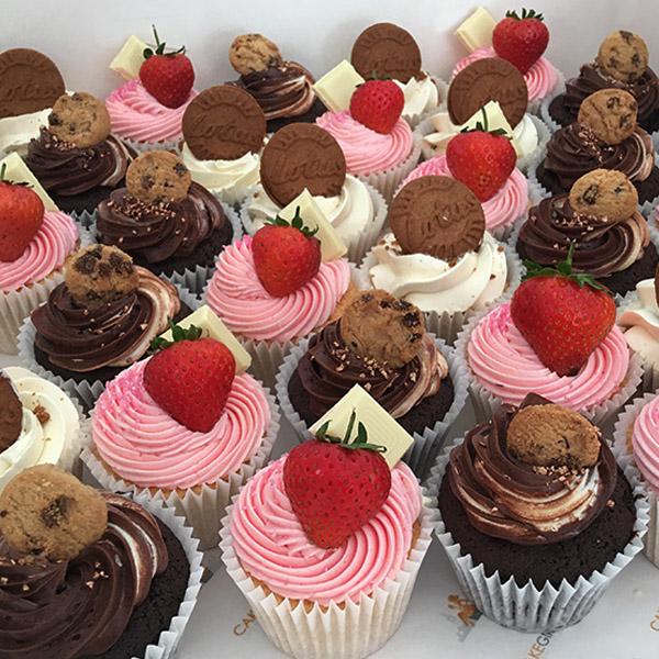 Vanilla & Chocolate Cupcakes topped with fresh strawberries, cookies and lotus biscuits.