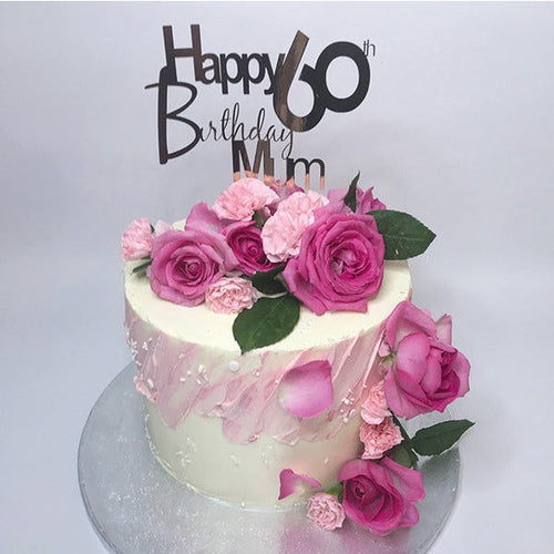 A light vanilla sponge cake, filled with layers of buttercream. Topped with fresh pink roses and carnations.