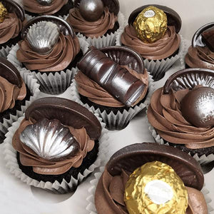 Chocolate topped cupcakes with Kinder Bueno, Ferrero Rocher, Guylian Belgian Chocolates and Terrys Chocolate Orange segments.